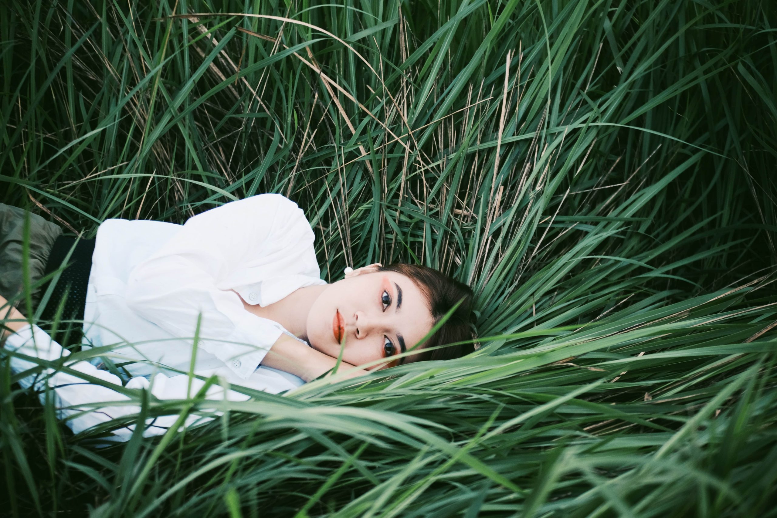 Woman lying down on grass